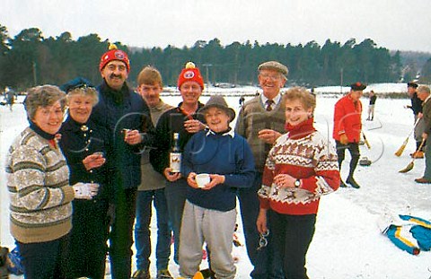 Keeping warm with a dram of Scotch at an   outdoor curling contest Grantown on   Spey Scotland