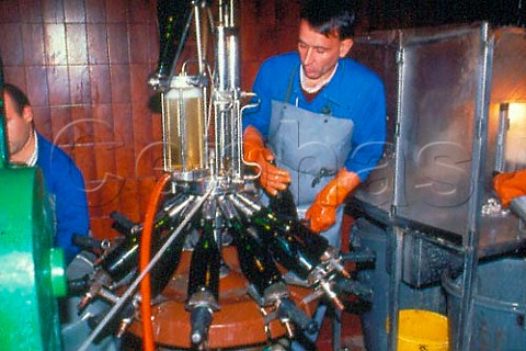 Adding dosage to bottles of Cava after   disgorging Bodegas Bilbainas Haro   La Rioja Spain