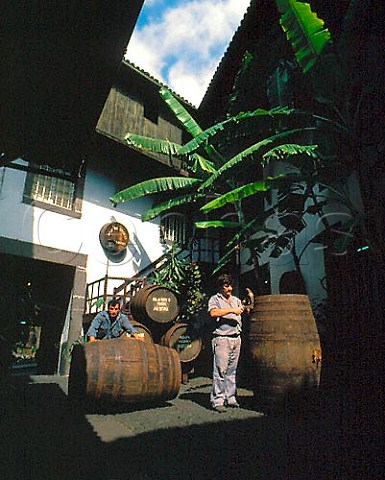 Tightening hoops on barrels in courtyard of Adegas   de Sao Francisco Funchal Owned by the Madeira Wine   Company