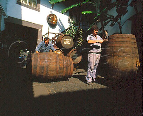 Tightening hoops on barrels in courtyard of Adegas   de Sao Francisco  owned by the Madeira Wine Company   Funchal Madeira
