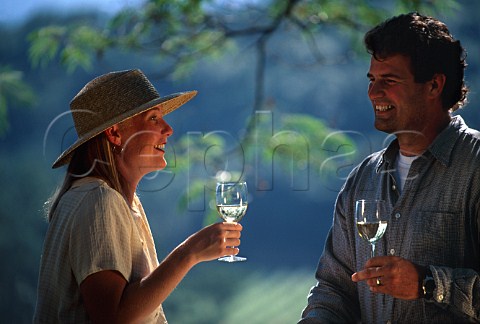 Couple drinking wine on the terrace of  Joseph Phelps Winery St Helena Napa Valley  California