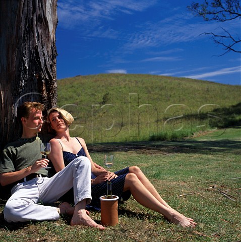 Couple drinking wine by gum tree   Kurrajong New South Wales Australia