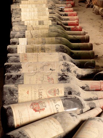 Bottles of vintage Bordeaux in a wine cellar