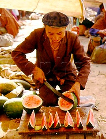 Selling slices of water melon Kashgar Sunday Market  Xinjiang Province China