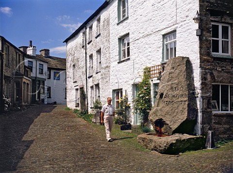 Stone fountain dedicated to the local geologist Adam Sedgwick in the cobbled main street of Dent village  Yorkshire England