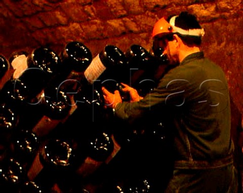 Performing the remuage on Methuselahs of sparkling   wine in the cellars of Cadel Bosco  Erbusco Lombardy Italy  Franciacorta