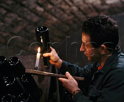 Checking the sediment in bottle of   sparkling wine in the cellars of Cadel Bosco  Erbusco Lombardy Italy  Franciacorta