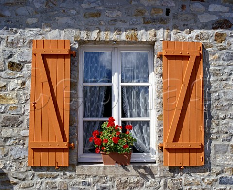 Cottage window with geranium and shutters at   StSauveur Manche France  BasseNormandie