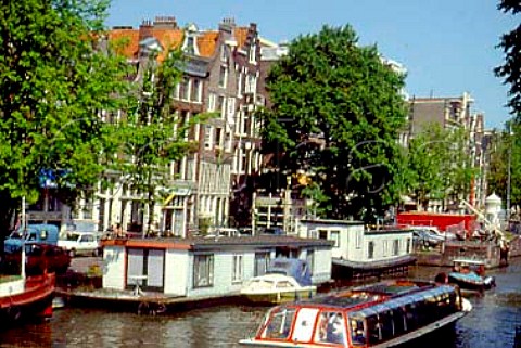 Houseboats and canal traffic along   Prinsengracht Princes Canal   Amsterdam Netherlands