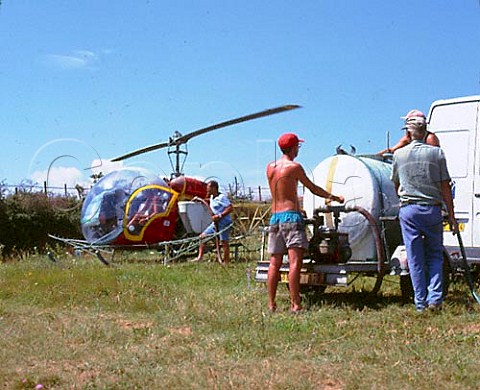 Filling the tanks on the sides of a helicopter ready   for spraying a vineyard on the Cte Rotie Ampuis   Rhne France