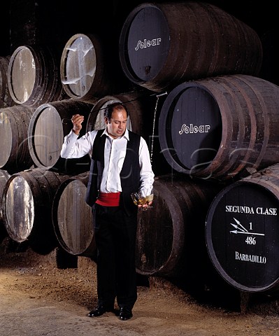 Venenciador Manuel Galvez filling glasses with Manzanilla from barrel in the Cathedral bodega of Antonio Barbadillo Sanlcar de Barrameda Andalucia Spain Manzanilla  Sherry