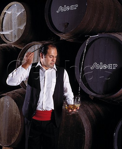 Venenciador Manuel Galvez filling glasses with   Manzanilla from barrel in the Cathedral bodega of   Antonio Barbadillo   Sanlcar de Barrameda Andalucia Spain   Manzanilla  Sherry