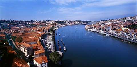 View down the Douro River with the Port lodges of Vila Nova de Gaia on the left and the waterfront area of Oporto Cais da Ribeira on the right  Portugal