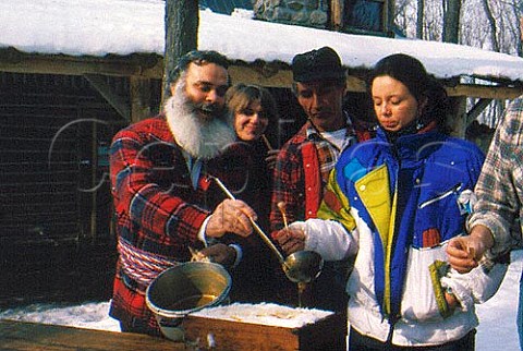 Tasting freshlymade Maple syrup at  Sucrerie de la Montagne La Tire  Rigaud Quebec Canada