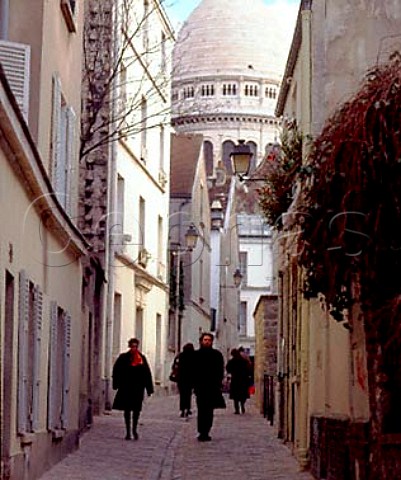 The narrow Rue StRustique leading to the   SacrCoeur in Montmartre Paris France
