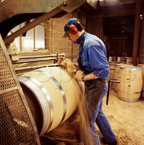 Finishing the exterior of a new barrel on a lathe at   Tonnellerie Lasserre Vertheuil Gironde France
