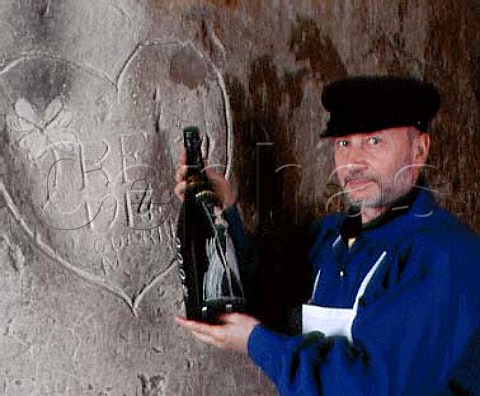 JeanPierre Girondin Chef de Caves with the special Millennium Magnum of Champagne Taittinger The graffito dates from 1914 when French soldiers were using the deep cellars to shelter from the bombing Reims Marne France 
