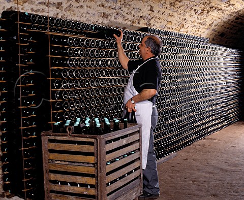 Stacking bottles to age sur lattes in the cellars   of Champagne Salon Le MesnilsurOger Marne   France