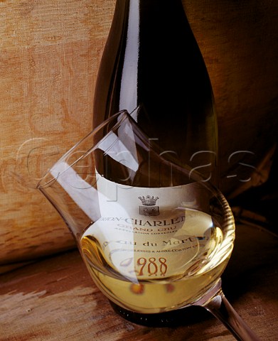 Bottle and glass of 1988 CortonCharlemagne   in the cellars of Domaine Bonneau du Martray      PernandVergelesses Cte dOr France  Cte de Beaune Grand Cru