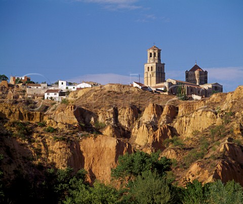 The 12thcentury church Colegiata de Santa Maria la Mayor stands on the cliff edge above the Duero River in the ancient wine town of Toro Castilla y Len Spain