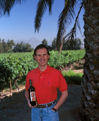 Ignacio Recabarren with bottle of his Domus Aurea in   vineyard of Clos Quebrada de Macul Chile  Maipo Valley