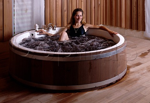 Woman in barrel bath at Les Sources de Caudalie wine   spa at Chteau Smith HautLafitte Martillac   Gironde France