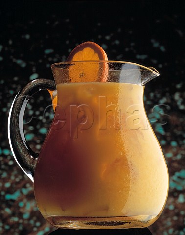 Jug of fresh orange juice with ice