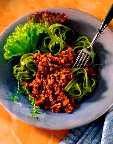 Pasta verde with meat and pepper sauce and salad