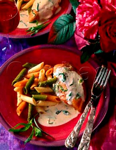 Penne with chicken breast in a cream sauce and a   glass of red wine