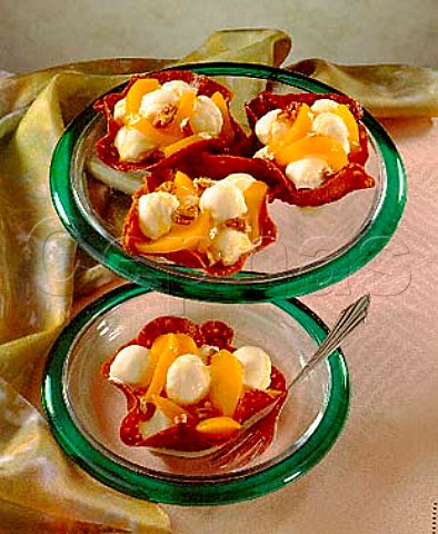 Dessert Peaches and icecream in walnut caramel  shells