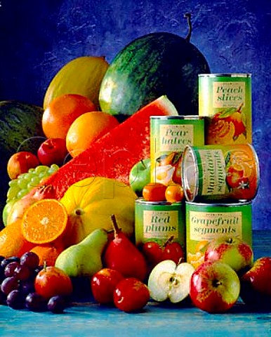 Tins of fruit and assorted fresh fruit