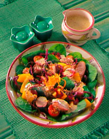 Warm sausage and orange salad with mustard dressing