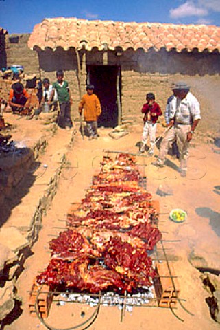 Cooking meat on an openair barbecue   Tarija Bolivia
