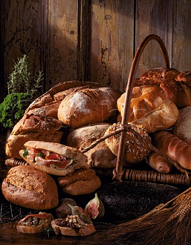 Bread Assorted breads with Prosciutto ham and fig  filled bread olive cheese and fig crostini and  green olive and fish crostini