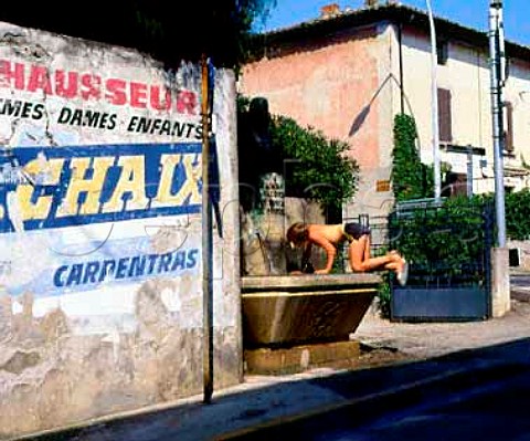 Boy drinking from fountain in Vacqueyras   Vaucluse France