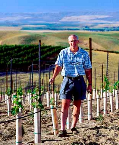 Rick Small in his recently planted Sauvignon Blanc   vineyard  the young vines are protected by grow   tubes which act as minigreenhouses  Woodward Canyon Winery Lowden Washington USA   Walla Walla Valley AVA