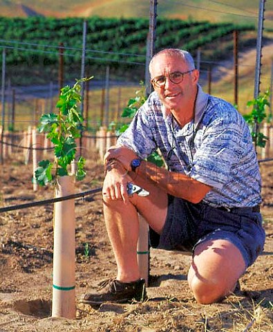 Rick Small in his recently planted Sauvignon Blanc   vineyard  the young vines are protected by grow   tubes which act as minigreenhouses  Woodward Canyon Winery Lowden Washington USA   Walla Walla Valley AVA