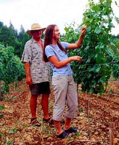 Ren Eichmann with his daughter Gabi tending a Pinot   Noir vineyard of Bear Creek Winery in the Illinois   Valley Cave Junction Oregon USA  Rogue Valley AVA