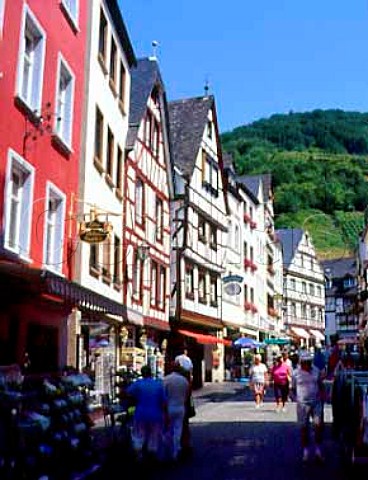 Rmerstrasser the main shopping street in   Bernkastel with the Schlossberg vineyard visible on   the hill beyond   Germany   Mosel