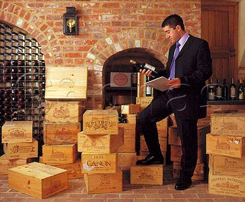 Vincent Gasnier cataloguing wines in a   clients cellar