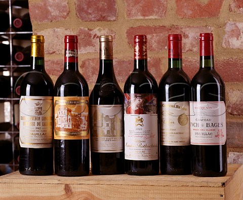 Bottles of Cru Class Bordeaux in a wine cellar  PichonLalande 1982 DucruBeaucaillou 1983   HautBrion 1985 Mouton Rothschild 1985   Cheval Blanc 1970 LynchBages 1982