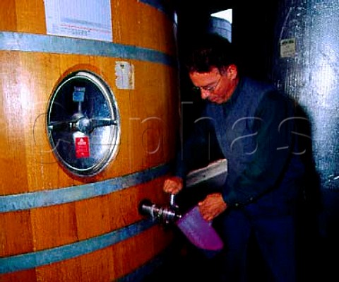 Jerry Egan manager of Robert Mondavis   Carneros Winery taking a sample of fermenting   Cabernet Sauvignon from tank to check its   specific gravity   Napa California