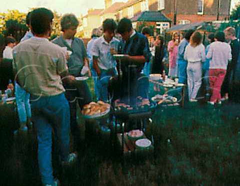 Teenagers having barbecue in a garden