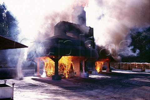 Burning maple for charcoal at the   Bourbon distillery of Jack Daniels   Tennessee USA