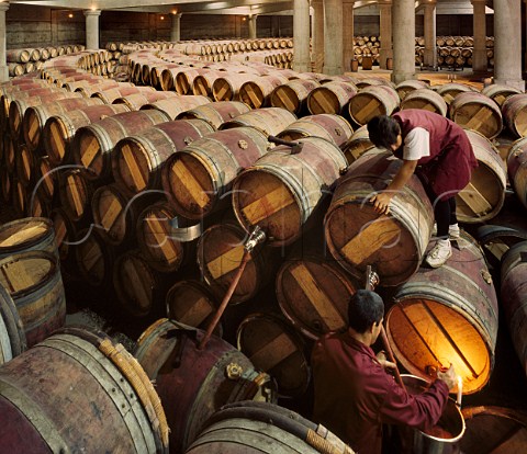 Racking wine in the circular barrel chai of Chteau LafiteRothschild Pauillac Gironde France   Mdoc  Bordeaux