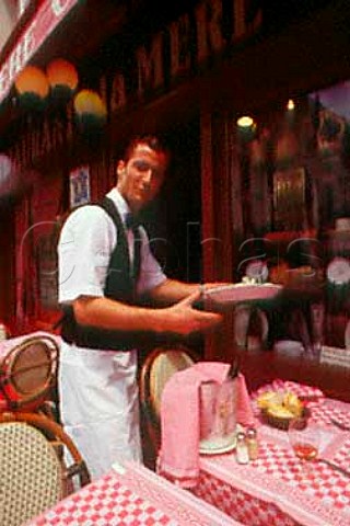 Waiter serving food at a French caf