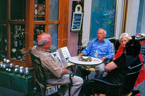People drinking wine outside a   weinstube Bernkastel Germany    Mosel