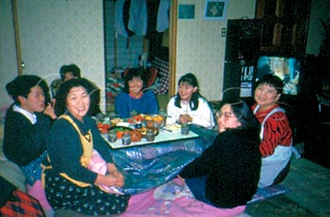 Japanese family and friends with typical   snacks on the kotatsu table Peanuts   green beans strawberries satsuma   oranges and biscuits  Nagano city   Nagano Prefecture Japan