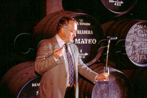 Eduardo Ojeda oenologist using a   venencia to take a sample of Tio Mateo   fino sherry from barrel in the bodgeas   Marques del Real Tesoro   Jerez Andaluca Spain    Sherry