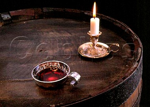 Tastevin of red wine with candle
